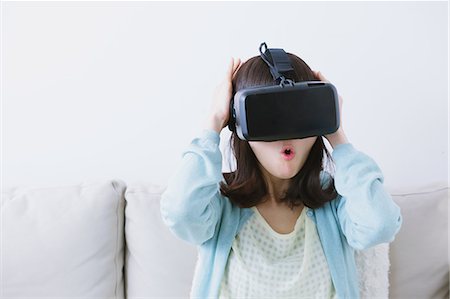 Japanese woman using virtual reality device Stock Photo - Premium Royalty-Free, Code: 622-08519687