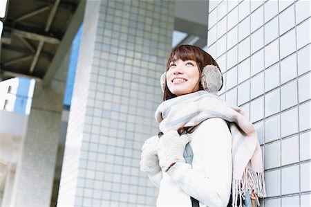 Attractive Japanese woman with muffler on a Winter sunny day Stock Photo - Premium Royalty-Free, Code: 622-08519720