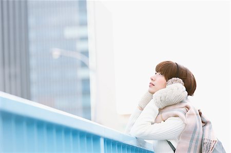 parapet - Attractive Japanese woman with muffler on a Winter sunny day Stock Photo - Premium Royalty-Free, Code: 622-08519723