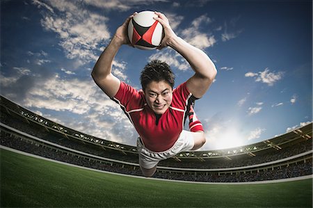 Portrait of Japanese rugby player diving to score a try Stock Photo - Premium Royalty-Free, Code: 622-08657625