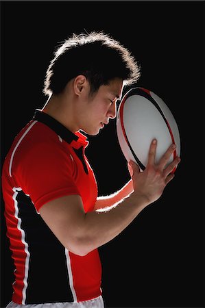 Portrait of Japanese rugby player with ball Stock Photo - Premium Royalty-Free, Code: 622-08657717