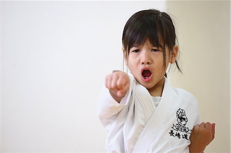female open mouth - Japanese kid in karate uniform training Stock Photo - Premium Royalty-Free, Code: 622-08657852
