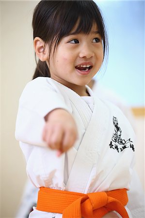 female martial arts poses - Japanese kid in karate uniform training Stock Photo - Premium Royalty-Free, Code: 622-08657853