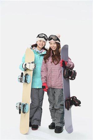 Young Japanese women wearing snowboard wear on white background Stock Photo - Premium Royalty-Free, Code: 622-08765641