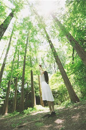 simsearch:622-09014015,k - Young Japanese woman surrounded by green in a city park Stock Photo - Premium Royalty-Free, Code: 622-08765667