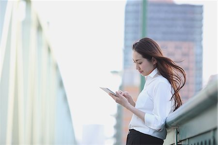 simsearch:622-09014015,k - Young Japanese businesswoman with tablet by a river downtown Tokyo Stock Photo - Premium Royalty-Free, Code: 622-08765685