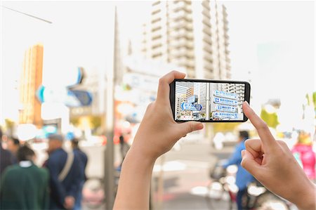 screen shot of phone - Japanese woman using augumented reality app on smartphone downtown Tokyo, Japan Stock Photo - Premium Royalty-Free, Code: 622-08839815