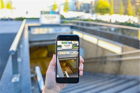 stairs closeup - Japanese woman using augumented reality app on smartphone downtown Tokyo, Japan Stock Photo - Premium Royalty-Free, Code: 622-08839829