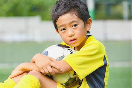 soccer player determined - Japanese kid playing soccer Stock Photo - Premium Royalty-Free, Code: 622-08893873