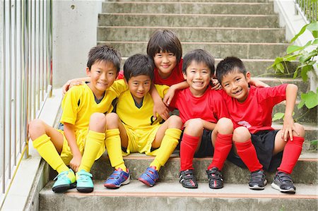 sports uniform - Japanese kids in soccer uniform on a staircase Stock Photo - Premium Royalty-Free, Code: 622-08893885