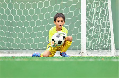 Japanese kid playing soccer Stock Photo - Premium Royalty-Free, Code: 622-08893908