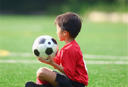 soccer field kid - Japanese kid playing soccer Stock Photo - Premium Royalty-Free, Code: 622-08893943