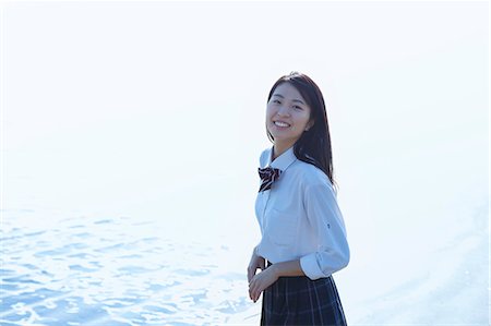 portraits of japanese women - Young Japanese woman in a high school uniform by the sea, Chiba, Japan Stock Photo - Premium Royalty-Free, Code: 622-08949169