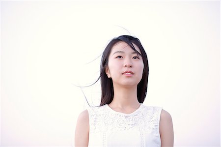 portraits of japanese women - Young Japanese woman in a white dress at a cliff over the sea at sunrise, Chiba, Japan Stock Photo - Premium Royalty-Free, Code: 622-08949287