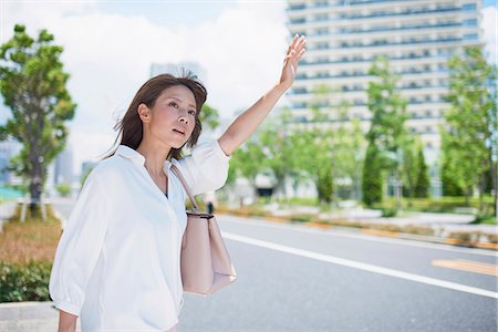 simsearch:622-09014015,k - Young Japanese woman calling a taxi downtown Tokyo, Japan Stock Photo - Premium Royalty-Free, Code: 622-09014007