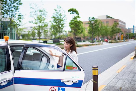 simsearch:859-06538343,k - Young Japanese woman riding a taxi downtown Tokyo, Japan Stock Photo - Premium Royalty-Free, Code: 622-09014017