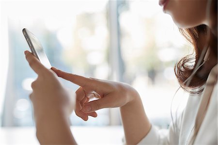 people with mobile phone - Japanese woman with smartphone in a stylish cafe Stock Photo - Premium Royalty-Free, Code: 622-09014659