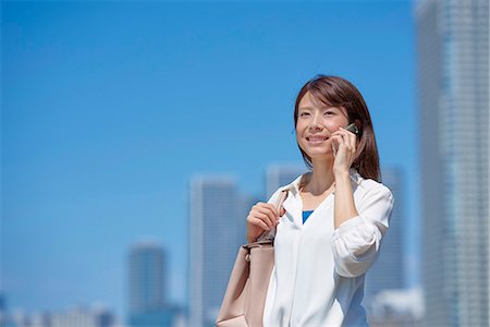 Portrait of young Japanese woman downtown Tokyo, Japan Stock Photo - Premium Royalty-Free, Code: 622-09013958