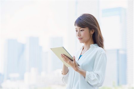 Portrait of young Japanese woman downtown Tokyo, Japan Stock Photo - Premium Royalty-Free, Code: 622-09013978