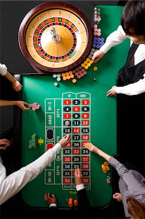 People betting at casino table Stock Photo - Premium Royalty-Free, Code: 622-09056229
