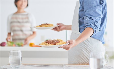 Japanese couple cooking together in the kitchen Stock Photo - Premium Royalty-Free, Code: 622-09056238