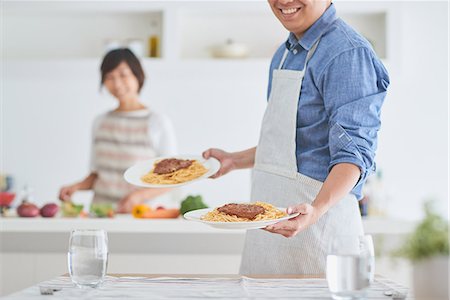 Japanese couple cooking together in the kitchen Stock Photo - Premium Royalty-Free, Code: 622-09056240