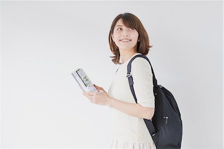 Young Japanese woman against white wall Fotografie stock - Premium Royalty-Free, Codice: 622-09169644