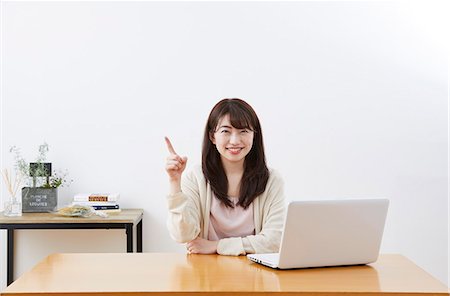 Japanese woman buying online Stock Photo - Premium Royalty-Free, Code: 622-09169789