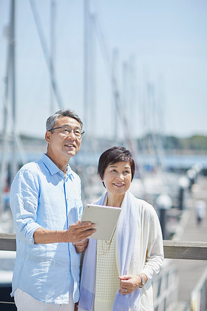 Japanese senior couple having fun by the sea Stock Photo - Premium Royalty-Free, Code: 622-09176083