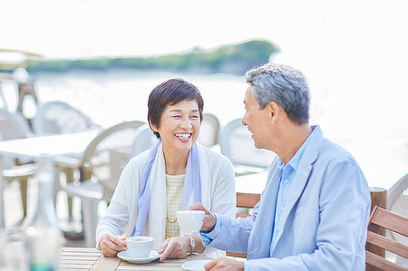 Japanese senior couple having a drink by the sea Stock Photo - Premium Royalty-Free, Code: 622-09176216