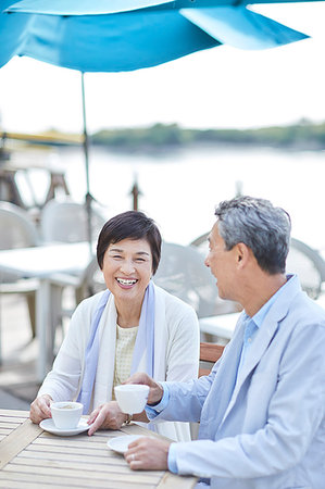 Japanese senior couple having a drink by the sea Stock Photo - Premium Royalty-Free, Code: 622-09176220