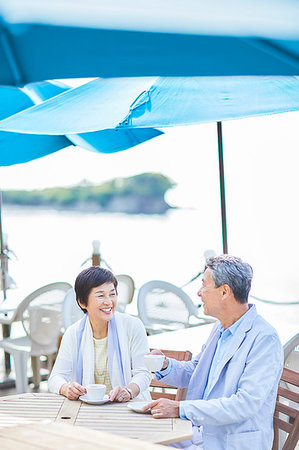 senior couple shopping outside - Japanese senior couple having a drink by the sea Stock Photo - Premium Royalty-Free, Code: 622-09176222