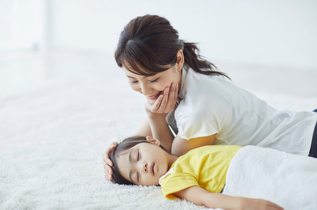 Japanese mother with sleeping kid Stock Photo - Premium Royalty-Free, Code: 622-09187384