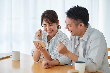 friends lifestyle city - Japanese couple in the living room Stock Photo - Premium Royalty-Free, Code: 622-09187492