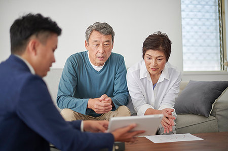 sales person with a tablet - Japanese senior couple talking with consultant Stock Photo - Premium Royalty-Free, Code: 622-09181447