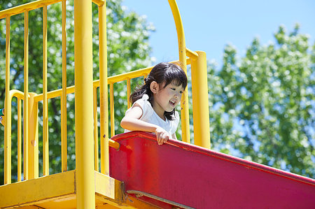 sky and park fence - Japanese kid in a city park Stock Photo - Premium Royalty-Free, Code: 622-09235955