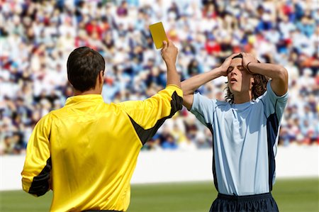 referee - Referee showing yellow card to disappointed player Stock Photo - Premium Royalty-Free, Code: 622-00701503