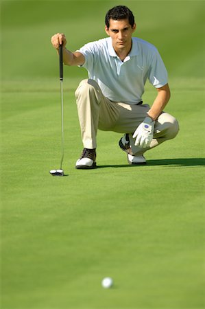 Man lining up a putt on the green Stock Photo - Premium Royalty-Free, Code: 622-00806992