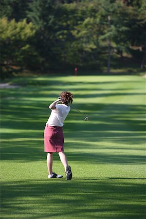 Vue arrière d'une golfeuse joue un coup Photographie de stock - Premium Libres de Droits, Code: 622-00807025