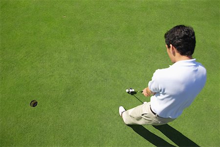 Male golfer making a putt Stock Photo - Premium Royalty-Free, Code: 622-00807029