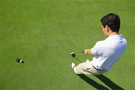 Male golfer making a putt Stock Photo - Premium Royalty-Free, Code: 622-00807031