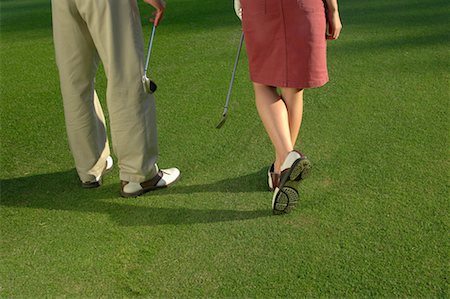 Waist down view of a couple holding golf clubs Stock Photo - Premium Royalty-Free, Code: 622-00807105