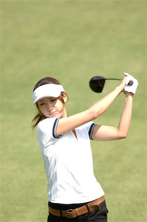 perfect balance - Vue de face d'une femme jouant un coup de golf Photographie de stock - Premium Libres de Droits, Code: 622-00807146