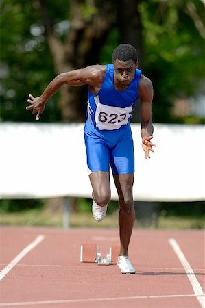 simsearch:622-00947146,k - Male Runner Sprinting Down a Track Stock Photo - Premium Royalty-Free, Code: 622-00947144