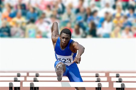 simsearch:622-00947146,k - Male Runner Clearing a Hurdle Stock Photo - Premium Royalty-Free, Code: 622-00947141