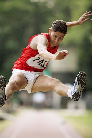 salto em distância - Male Long Jumper Leaping Foto de stock - Royalty Free Premium, Número: 622-00947167