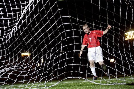 Soccer Player Behind Waving Net Stock Photo - Premium Royalty-Free, Code: 622-00947313