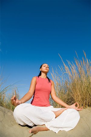 picture of a girl sitting in padmasana - Young woman doing yoga exercises Stock Photo - Premium Royalty-Free, Code: 622-01080581