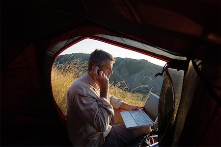 Camper with mobile and laptop Stock Photo - Premium Royalty-Free, Code: 622-01080645