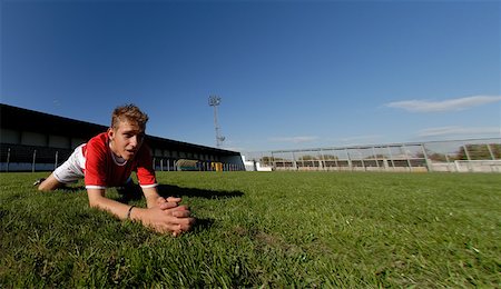 simsearch:622-01283855,k - Boy stretching on a pitch Stock Photo - Premium Royalty-Free, Code: 622-01283747